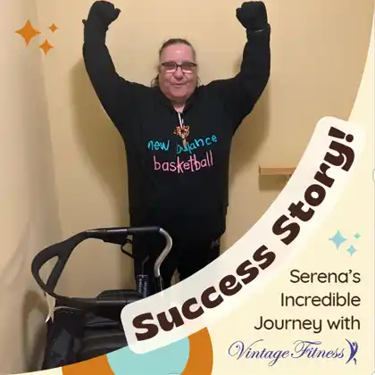 Serena celebrating her fitness success, standing proudly with her arms raised in victory, wearing a New Balance basketball hoodie. She’s a Vintage Fitness success story, having regained mobility and improved her health with expert training.