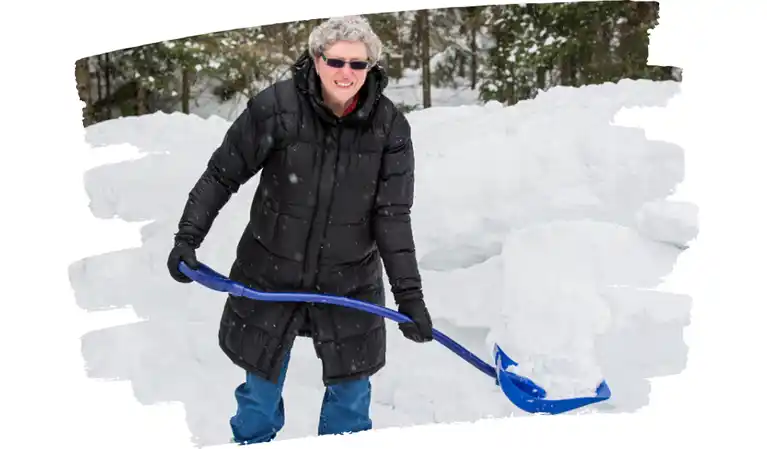 Senior man shoveling snow safely using proper technique to avoid injury, demonstrating strength and balance.s