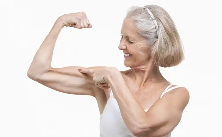 proud senior showing off her muscles