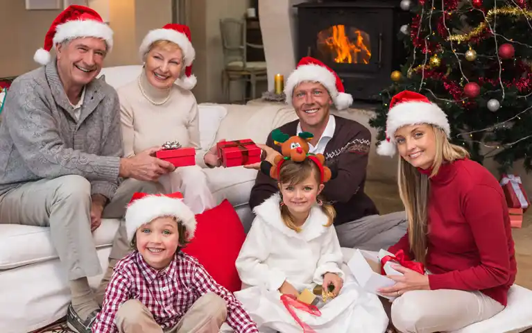 Three generations enjoying christsmas, grandparents, kid and grandkids.