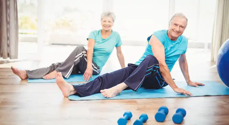 Couple of Senior exercising on the floor