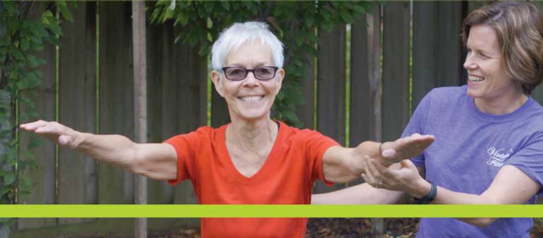 Personal trainer and senior working out in the backyard